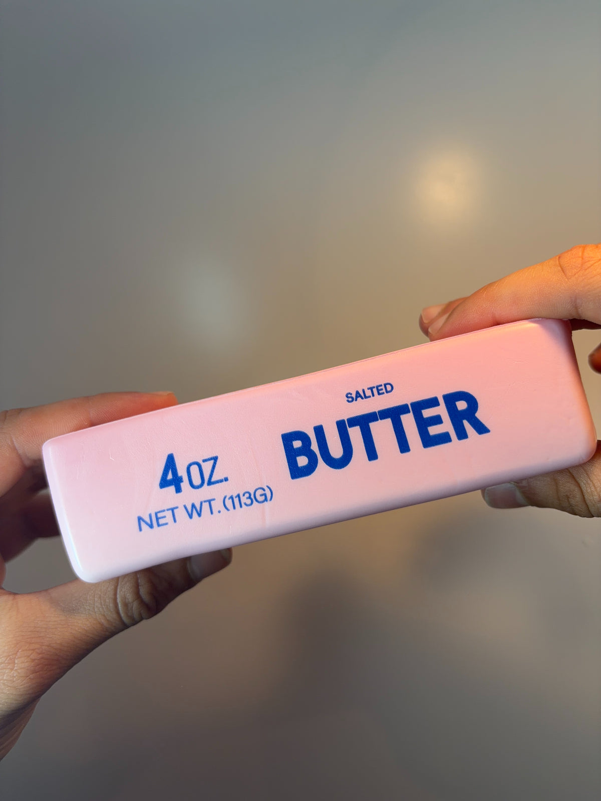 Pink butter squishy held in a hand