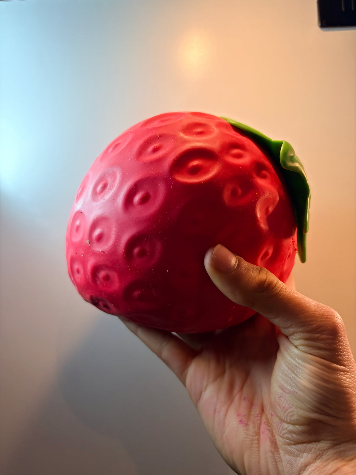 Jumbo strawberry squishy held in both hands